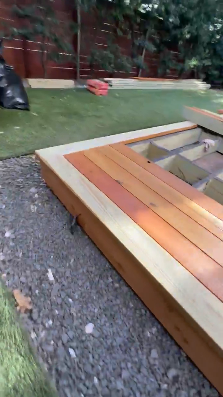 Close corner detail of the cedar picture-frame border meeting over the joist grid